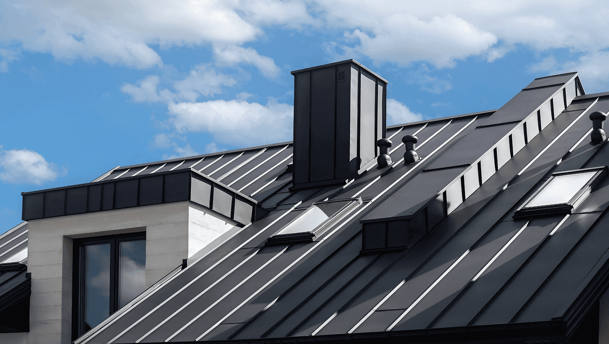 Modern house with metal roof and chimney.